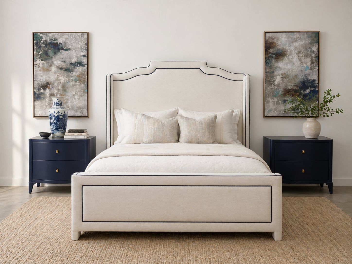 Cream scalloped-shape headboard with matching footboard and navy nightstands