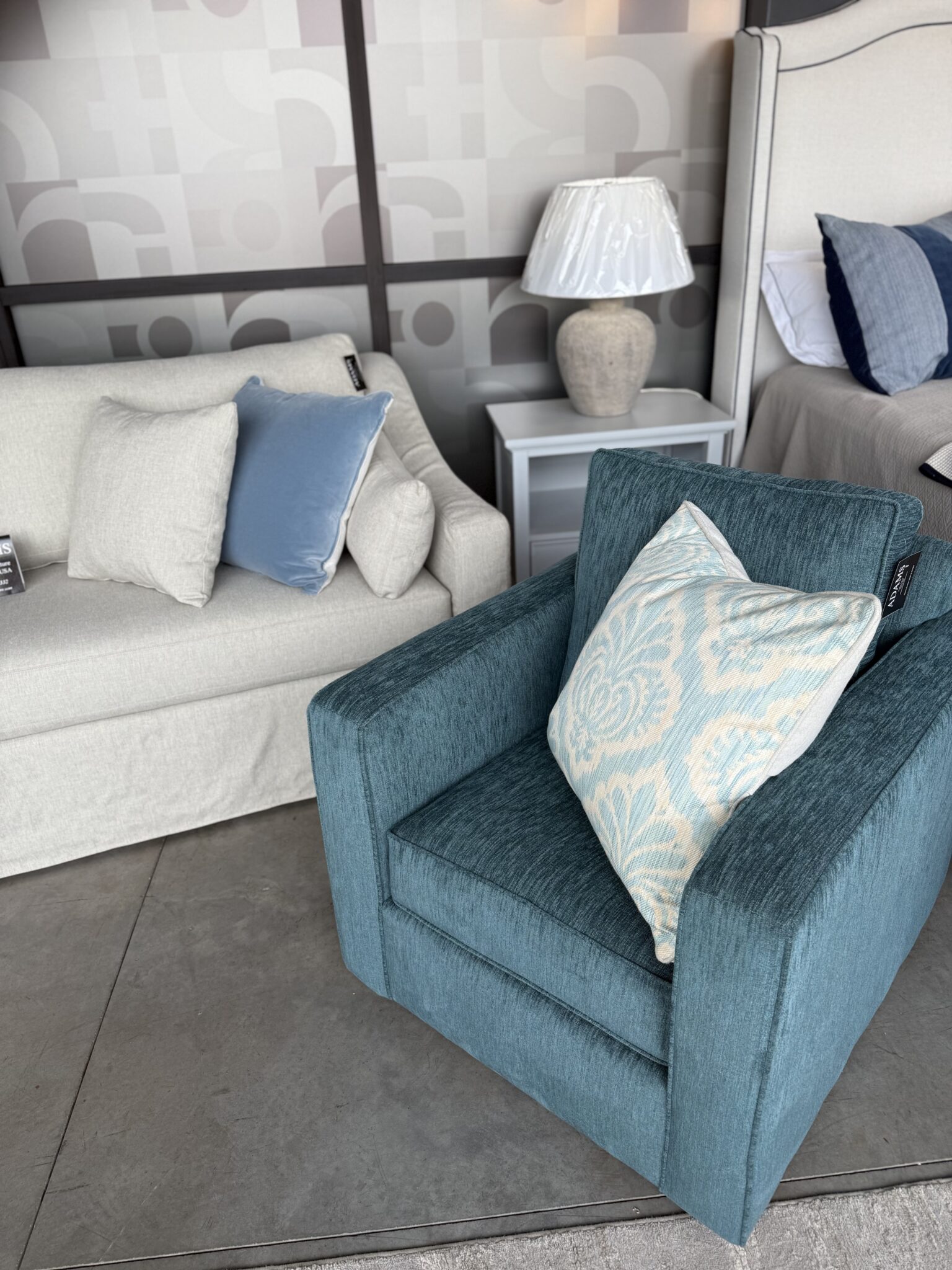 Cream sofa with teal accent chair vignette