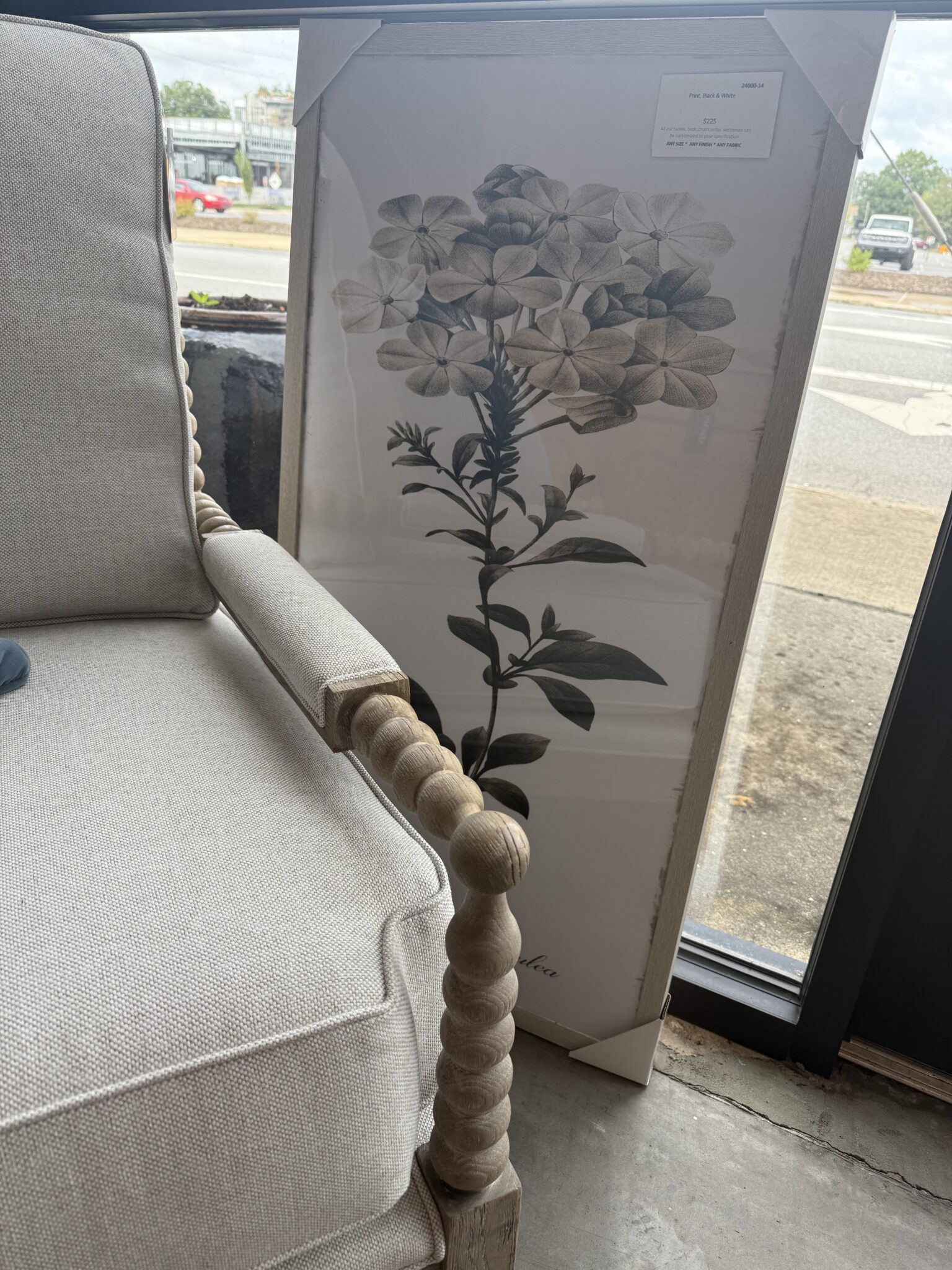 Botanical artwork beside cream beaded chair