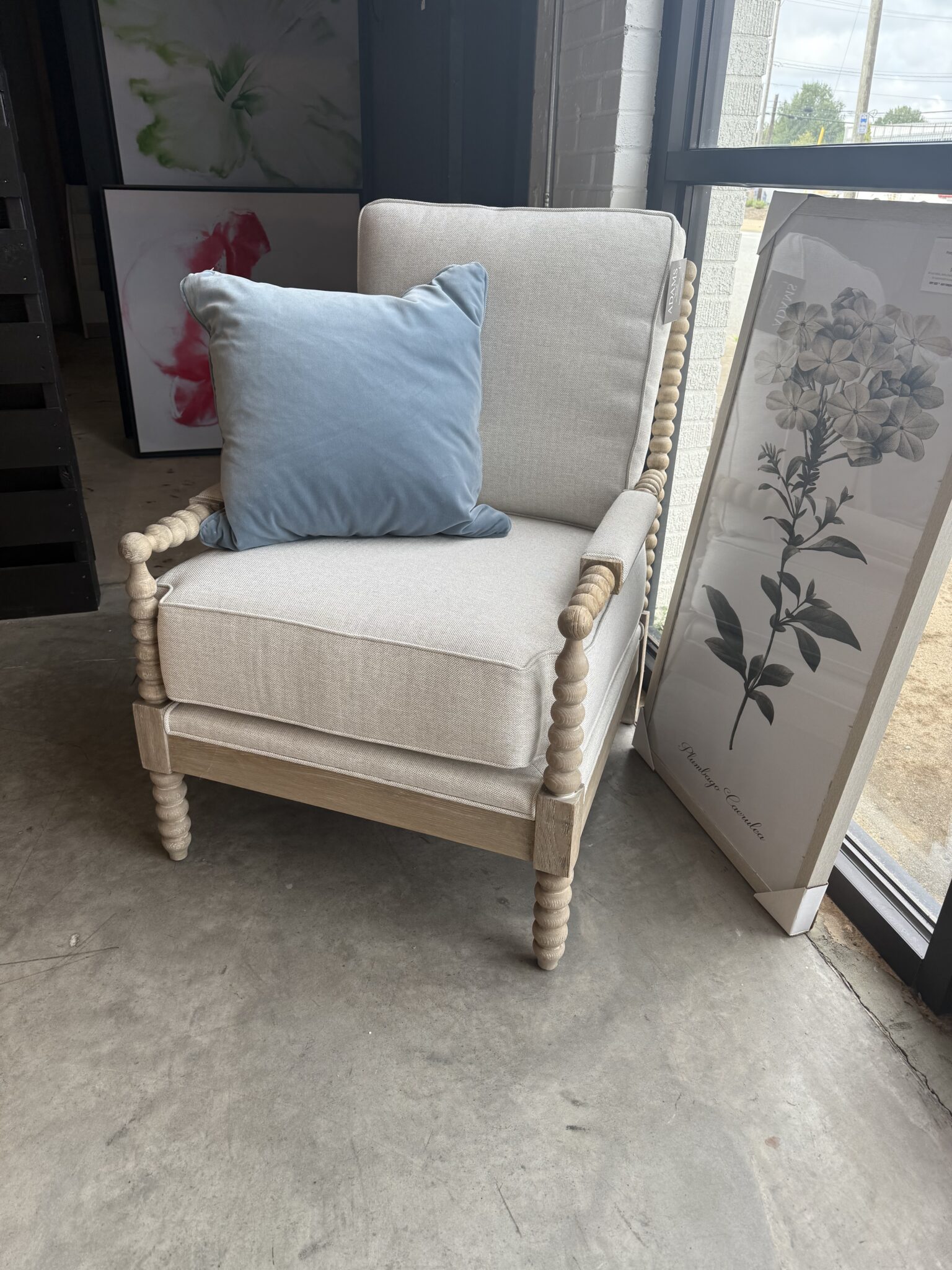 Cream beaded armchair with blue velvet pillow